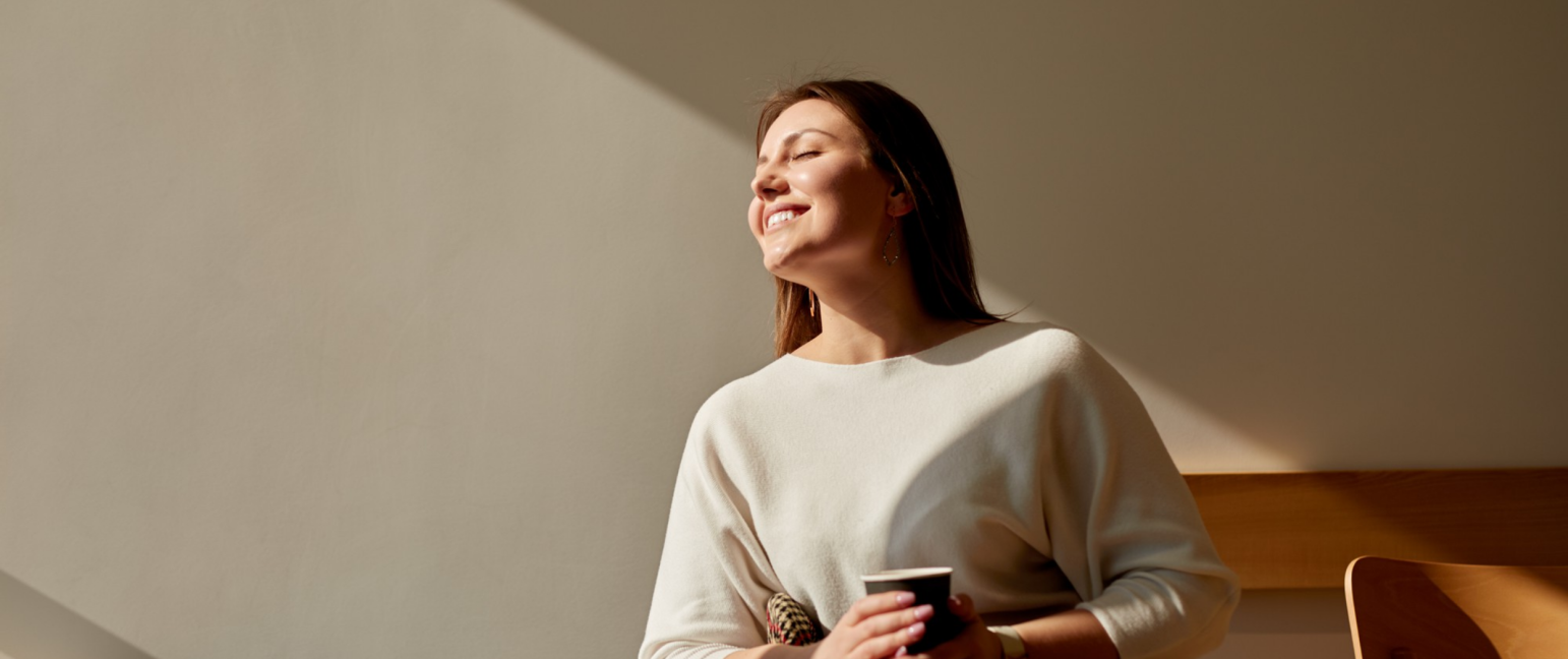 happy woman enjoying morning coffee cafe